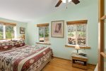 Bedroom 1 has warm cabin-style interiors